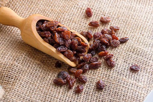 Raisins in a wooden scoop