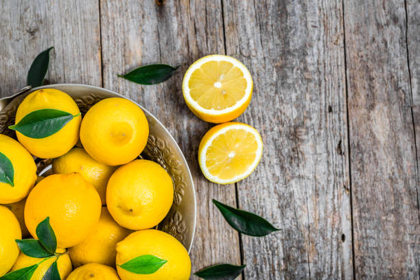 istock Fresh lemons on market table, top view 648671912