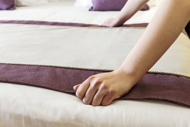 istock female hands corrected blanket on the bed 648671964