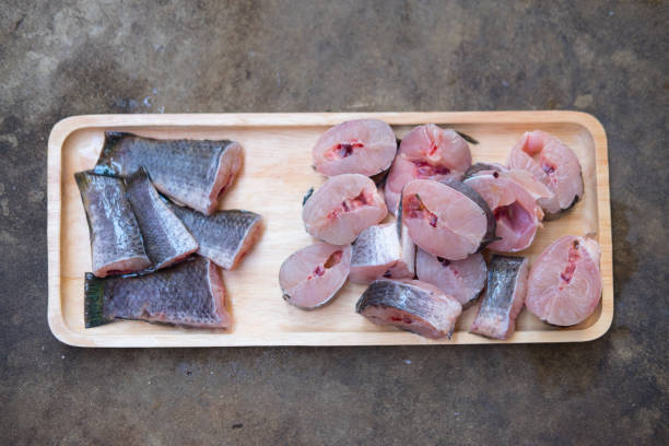istock Striped snakehead fish chopped preparing for cooking on wood tray 648675052