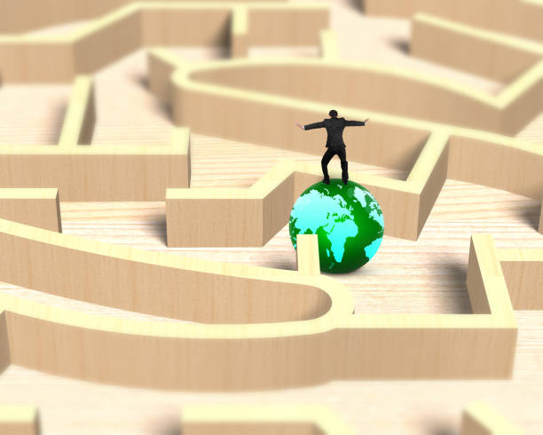 istock Man balancing on globe in wooden maze game 648675156