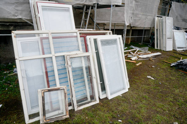istock Old wooden windows are withdrawn from the building for replacement by new plastic windows 648676320