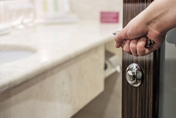 istock Hand opens the door to the bathroom 648679488