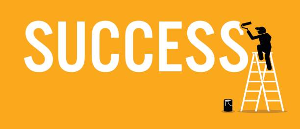 istock Painter painting the word success on a wall by climbing up a ladder. 648679896