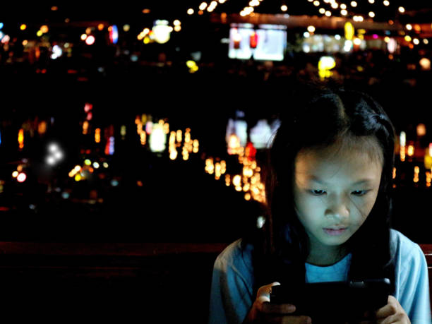 istock child and  the mobile phone on bokeh backgrounds 648683100