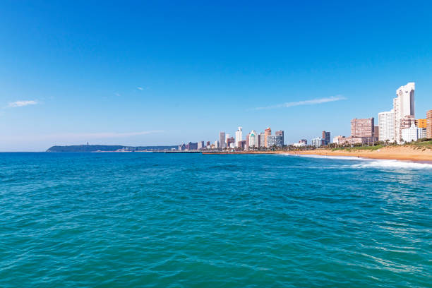 istock Coastal Landscape Beach Ocean Blue Sky and City Skyline 648683132