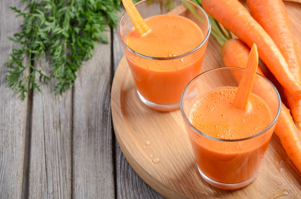 istock Fresh carrot juice on wooden background 648687782
