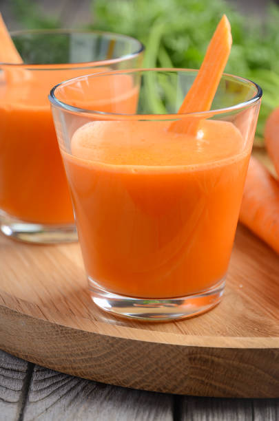 istock Fresh carrot juice on wooden background 648687784