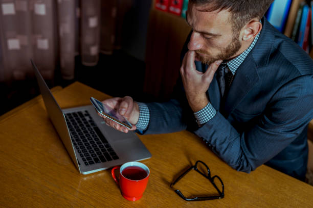 istock Young Man Working Late in his Office 648694608