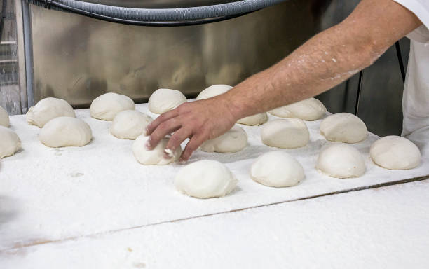 istock Hands hold the dough and the bread 648694680