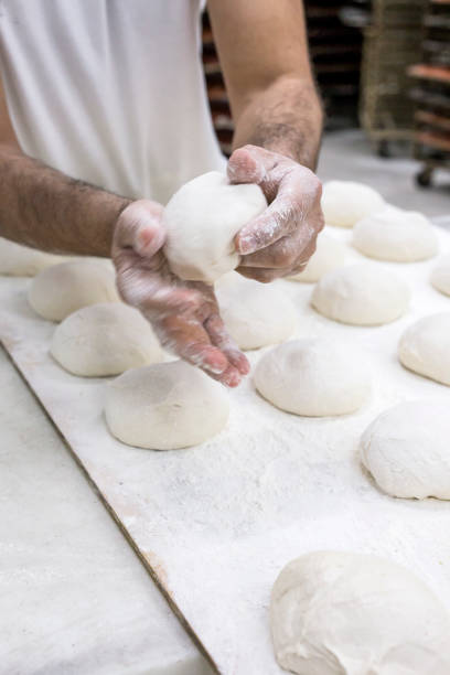 istock Hands hold the dough and the bread 648694712