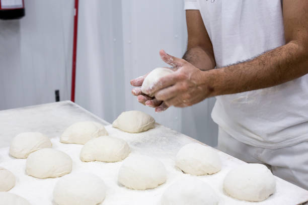 istock Hands hold the dough and the bread 648694714