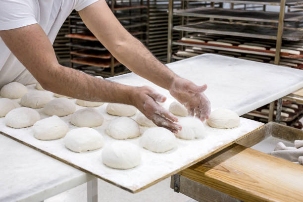 istock Hands hold the dough and the bread 648694724