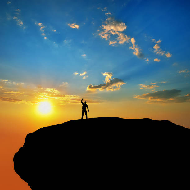 istock Man silhouette on peak of mountain. Element of design. 648695258