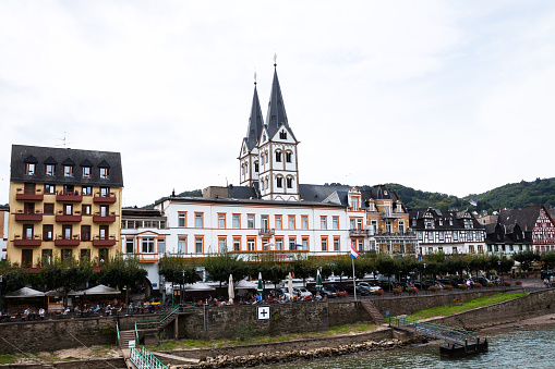 Center of city Bad Salzig in Rhineland-Palatinate seen from river Rhine. In center is a church.