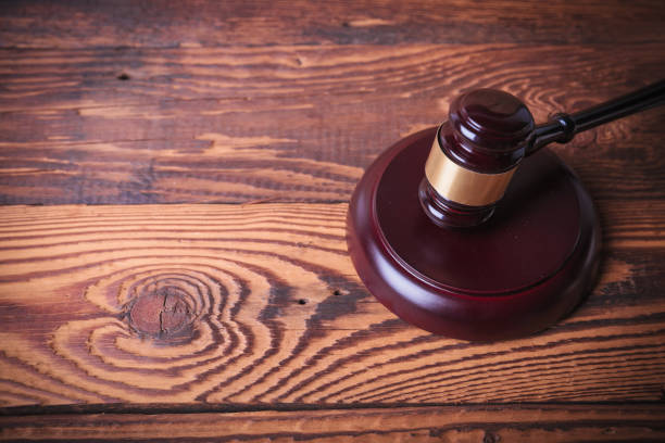 istock judge's gavel on old fir wood background 648700470