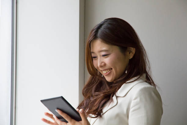 istock Woman Is Watching Tablet With Smile 648700848