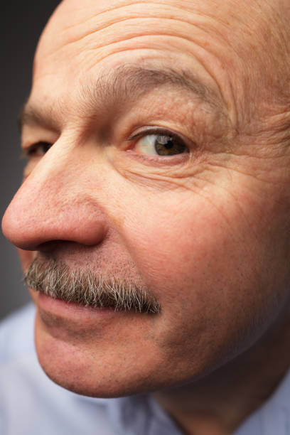 istock Funny senior man looks in camera close up 648705238