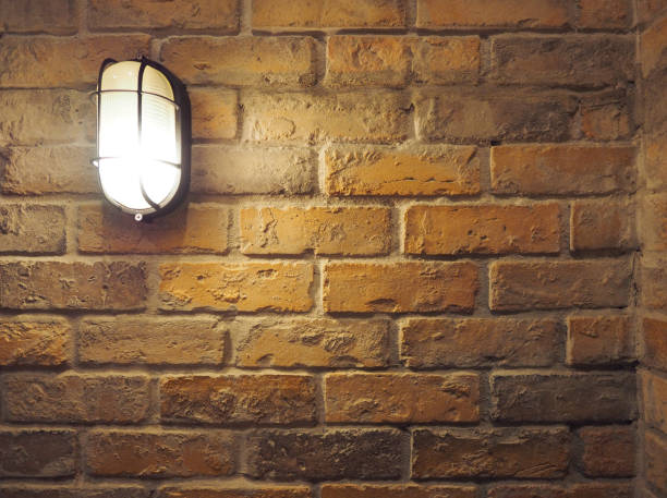 istock Brick wall old dirty texture background and hanging lamp. 648710676
