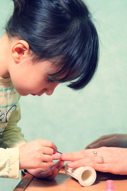 istock play Manicure. Mom and daughter. 648714834