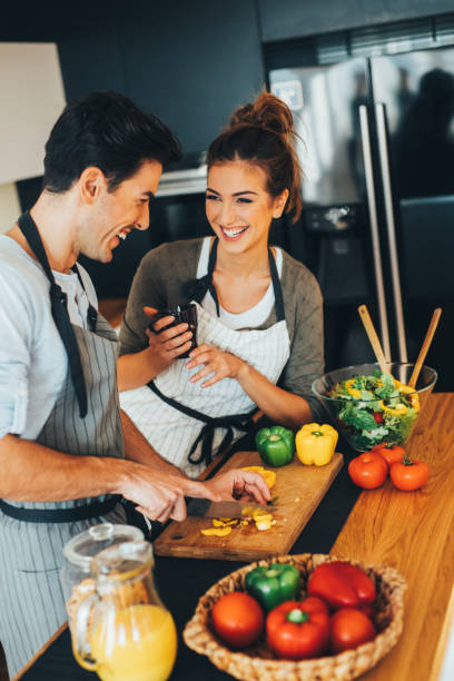 istock Man helping his girlfriend with the cooking 648717784