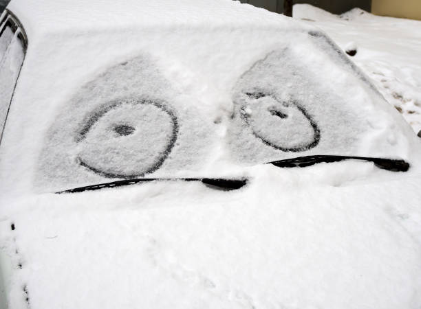 istock Car covered with snow with a painted on the windshield mug 648720684