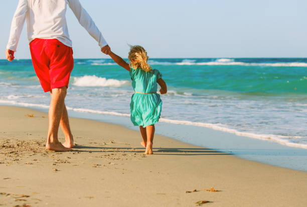 istock father and little daughter play at beach 648721038