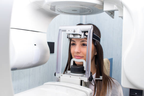Girl taking digital 3D panoramic dental x-ray. Close up head shot of girl taking dental tac with cephalometric panorama x-ray machine in clinic. 3d scanning photos stock pictures, royalty-free photos & images