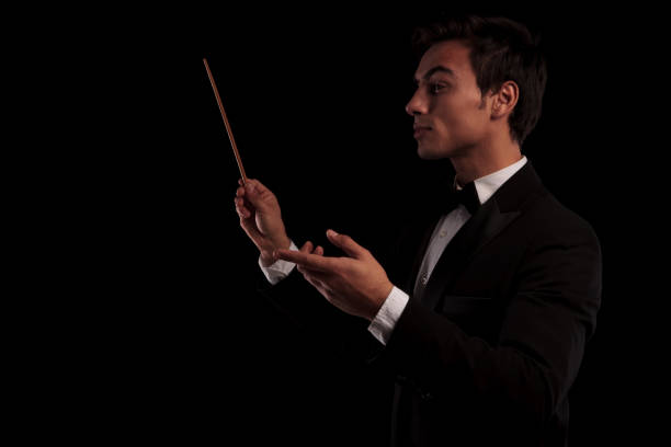 istock side view of an elegant music conductor holding a batton 648730136