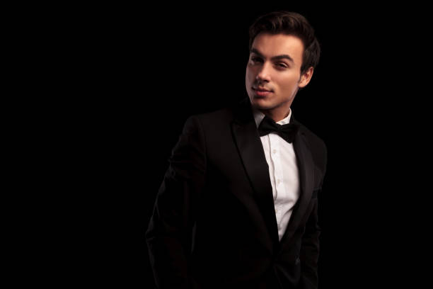 istock cool young man in tuxedo and bowtie posing 648731176