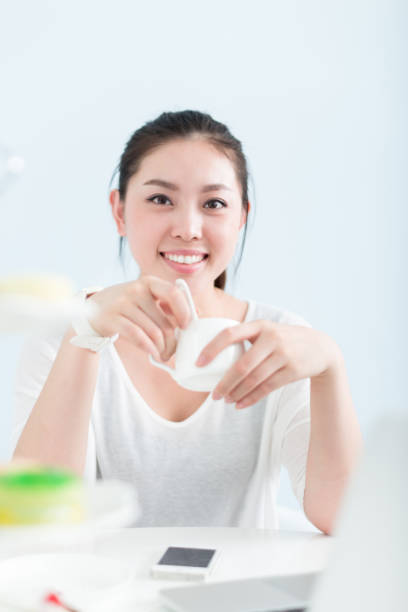 istock young pretty woman using laptop in office 648732454