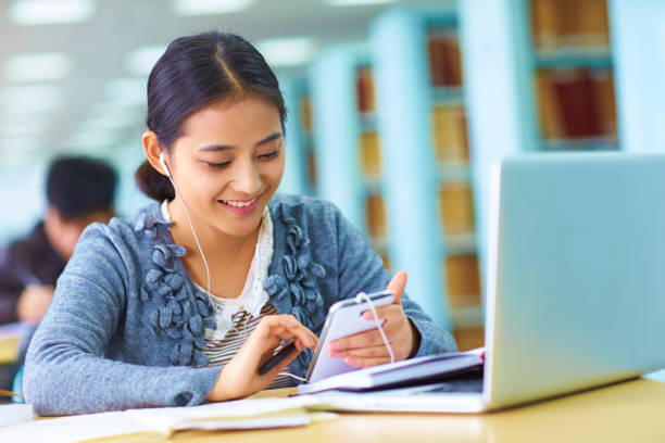 istock One pretty young asian college student study in the library 648733240