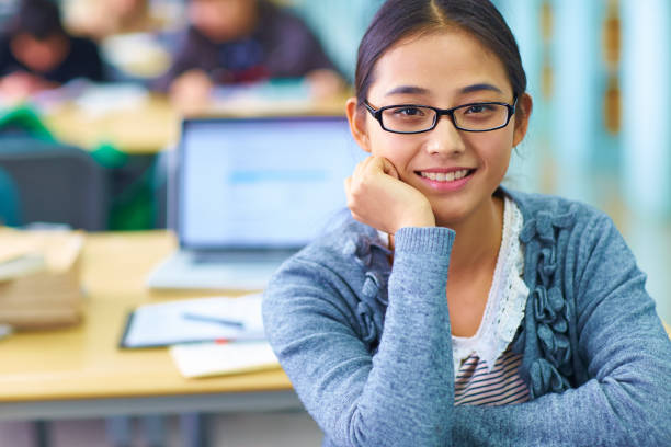 istock One pretty young asian college student study in the library 648733264