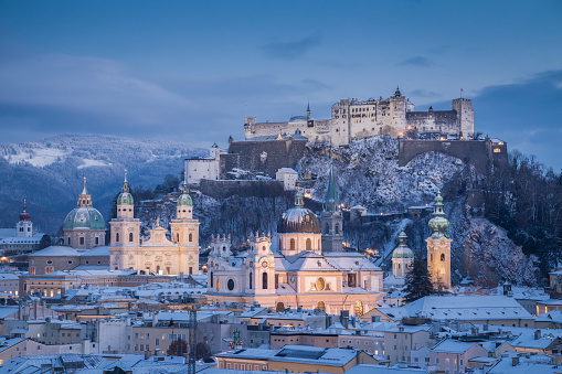 Classic view of the historic city of Salzburg with famous Festung Hohensalzburg and Salzburger Dom illuminated in beautiful twilight during scenic Christmas time in winter, Salzburger Land, Austria