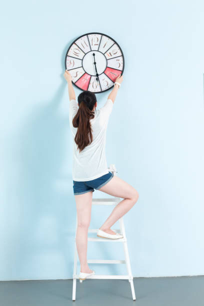 istock young pretty woman with clock 648737448