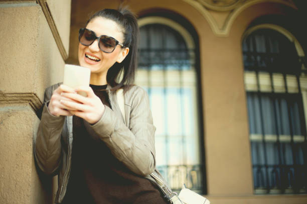 istock Smiling young women using mobile phone 648746912