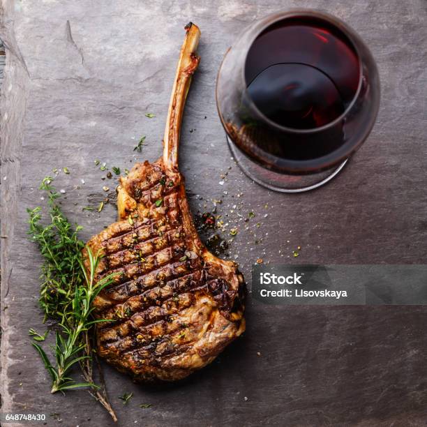 Grilled Beef Barbecue Veal Rib Steak On Bone And Red Wine Stock Photo - Download Image Now