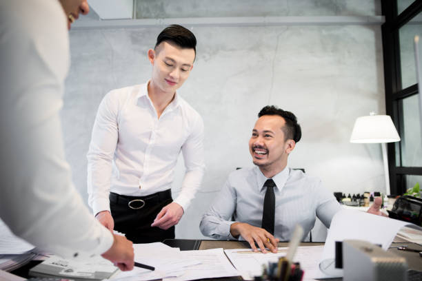istock Asian colleagues discussing work in the office 648752688