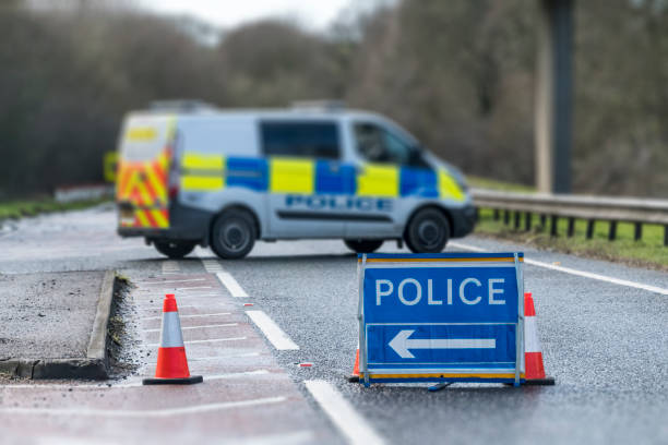 Police Sign on Road with Police Van A police sign and van on a closed road. road closed sign horizontal road nobody stock pictures, royalty-free photos & images