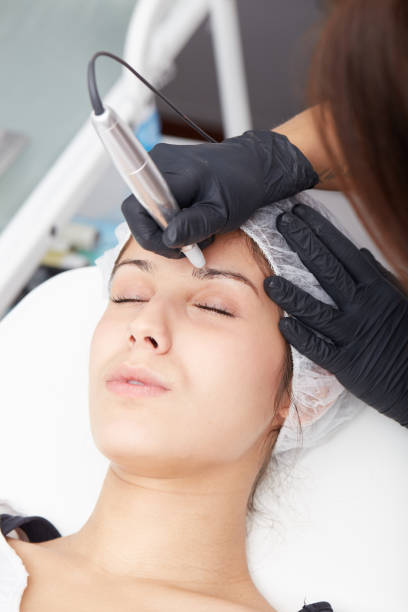 istock professional tattooist making eyebrow make up 648767658