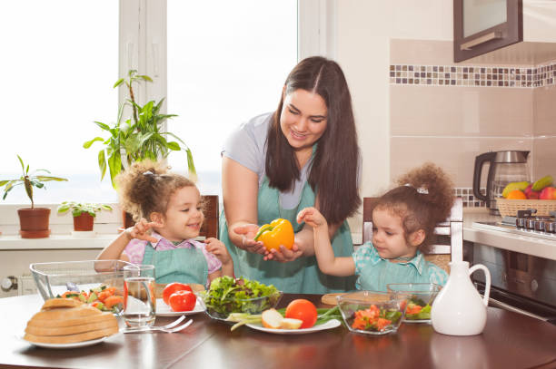 istock Family preparing meal together 648768632