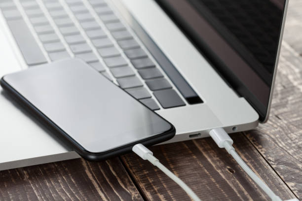 close-up usb cable connect phone and laptop computer new technology concept