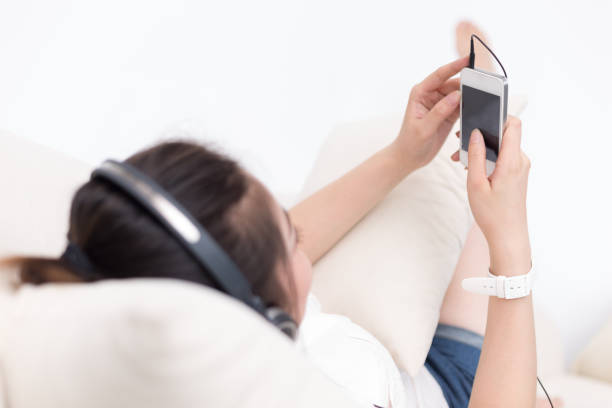 istock young pretty woman relaxes with mobile phone 648769272