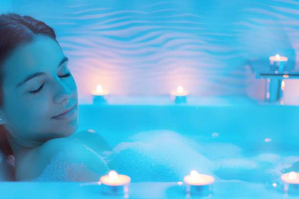 istock Woman in foam bath with candles. 648773750
