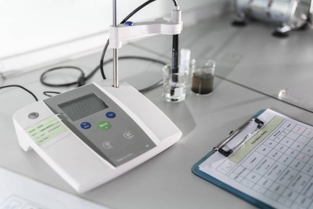 istock Laboratory research, flask containing chemical liquid with microscope 648777250