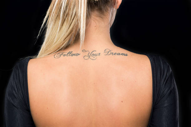young girl with a tattoo young girl with a tattoo on her back back shoulder tattoos for women pictures stock pictures, royalty-free photos & images