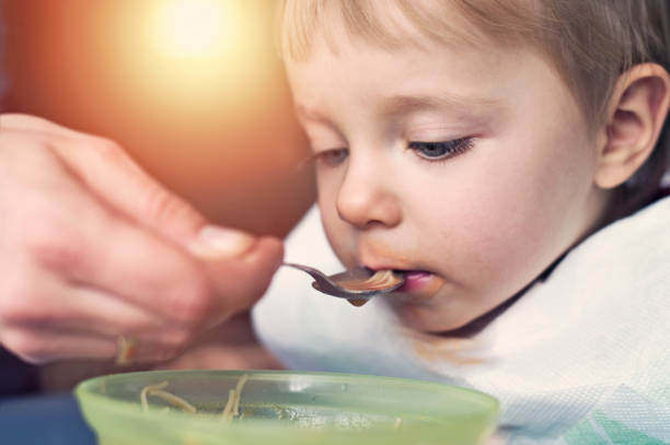 istock Little baby boy eating tomato soup 648777382