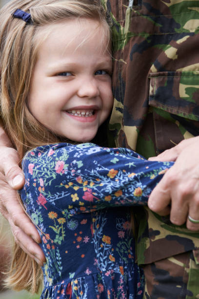 istock Soldier On Leave Being Hugged By Daughter 648777636