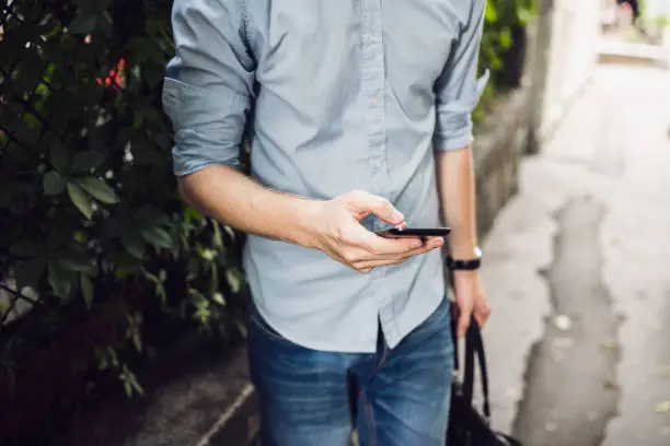 Close up of a handsome man playing pokemon go