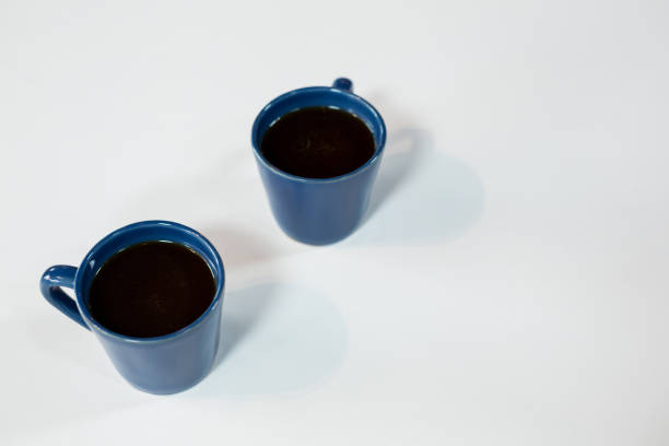 istock Two cups of black tea on white background 648781978